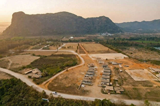 Aerial view of the Phaview development site amid Vang Vieng's limestone karst mountains